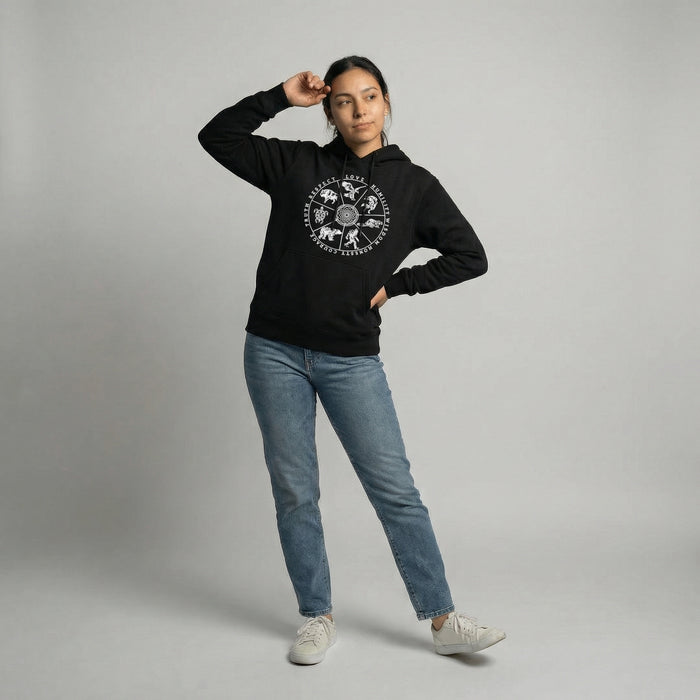 Model wearing a 7 Teachings Wheel Hoodie showcasing a unique design on a cozy black sweatshirt.