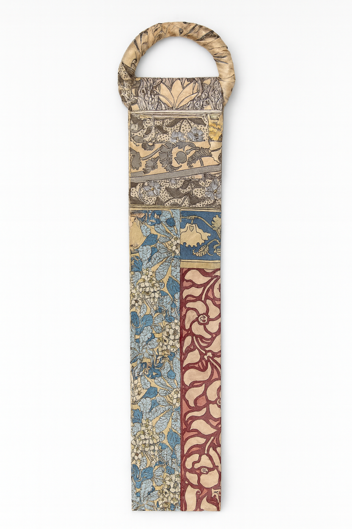 Wide boho floral print belt with mixed-color patchwork detail and a circular buckle.