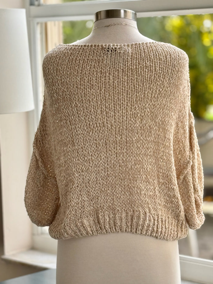 back of knitted sweater with gold thread