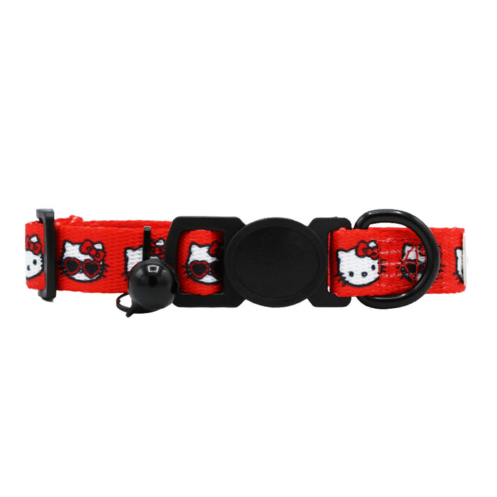 The Sassy Woof Cat Collar - Hello Kitty® Red Classic features an adjustable red strap with Hello Kitty faces, a small black bell, a black plastic buckle, and a D-ring for attachments.
