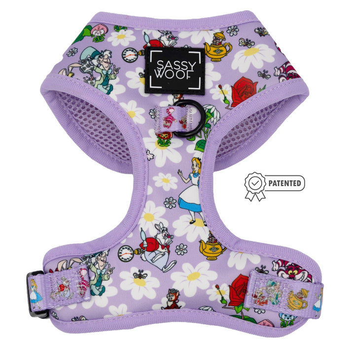 The Sassy Woof Dog Adjustable Harness - Alice in Wonderland (Purple) features whimsical teapots, roses, and white daisies. The patented symbol appears on the right side of the image.