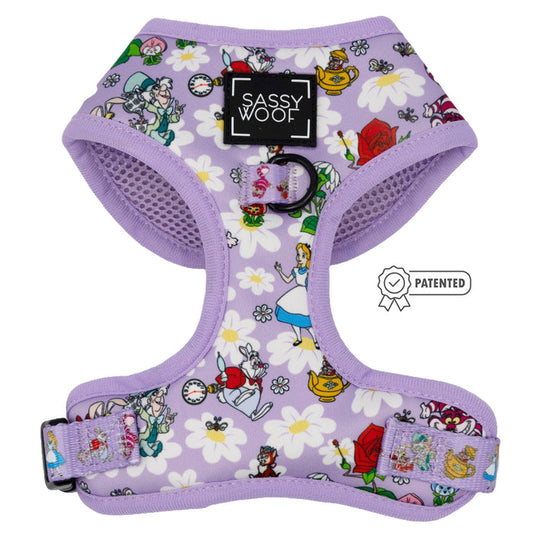 The Sassy Woof Dog Adjustable Harness - Alice in Wonderland (Purple) features whimsical teapots, roses, and white daisies. The patented symbol appears on the right side of the image.