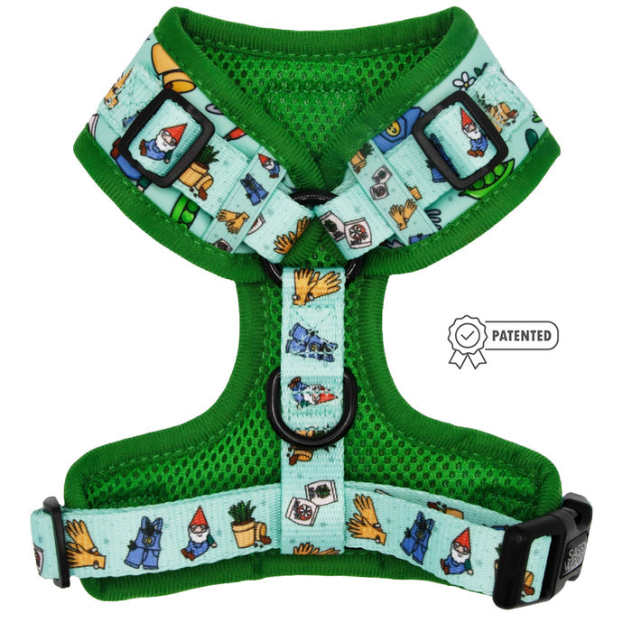 The Sassy Woof Dog Adjustable Harness - Chillin with my Gnomies is a green mesh harness with light blue straps, decorated with playful gnome, plant, dog, glove, and gardening tool illustrations. Displayed flat with a Patented badge.