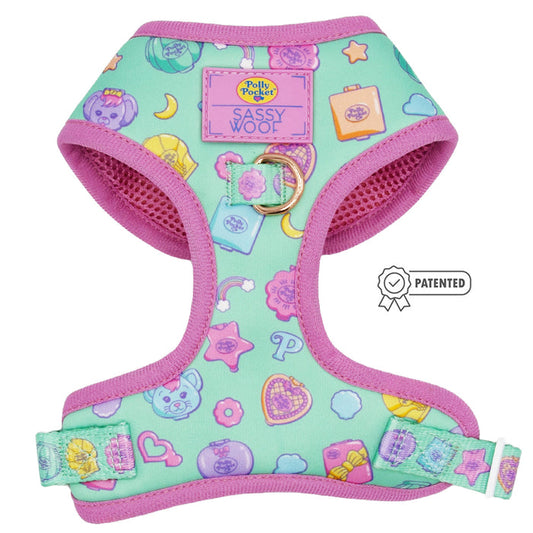 The Sassy Woof Dog Adjustable Harness - Polly Pocket™ features a mint green and pink design with playful cartoon icons, Polly Pocket and Sassy Woof logos, a patented badge on the right, and is part of our Puppy Growth Pawtection Plan.