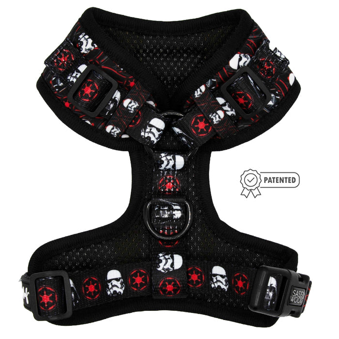 The Sassy Woof Dog Adjustable Harness - STAR WARS™ The Dark Side is a black, no-pull dog harness featuring red and white Stormtrooper helmets and Imperial symbols, with adjustable straps and a "PATENTED" label.
