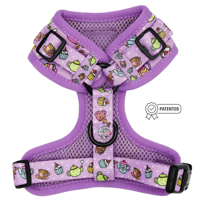The Sassy Woof Dog Adjustable Harness - Tea Pawty features a purple mesh chest, teapot, cup, and cupcake strap design, black buckles, slides, D-ring, and a patented side label—ideal for protecting growing puppies.