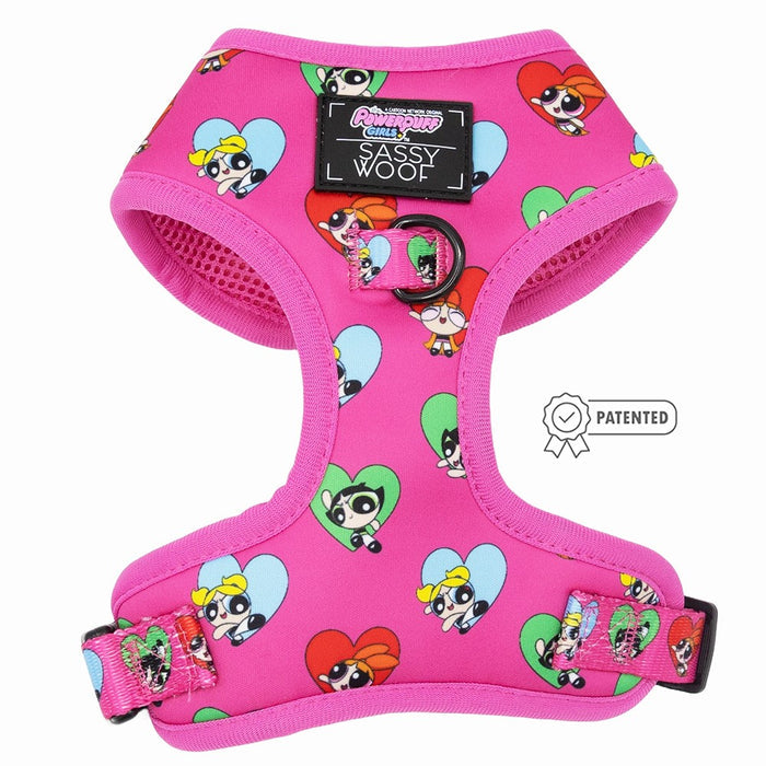 The Sassy Woof Dog Adjustable Harness – The Powerpuff Girls™ (Love) is a bright pink harness with Powerpuff Girls and heart prints, a black Sassy Woof label, metal leash ring, and patented icon—perfect for fans seeking a fun harness!.