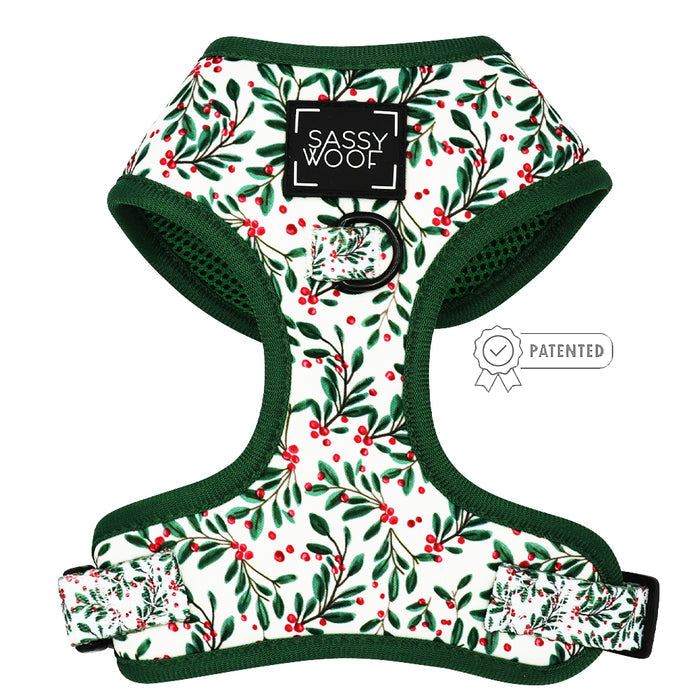 The Sassy Woof Dog Adjustable Harness - Under the Mistletoe is a small, green and white harness for dogs.