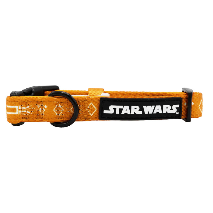 The Sassy Woof Dog Collar - STAR WARS™ Ahsoka features an orange adjustable design, black plastic buckle, metal ring, light embellishments and stitching, plus a patch with the white Star Wars logo on a black background.