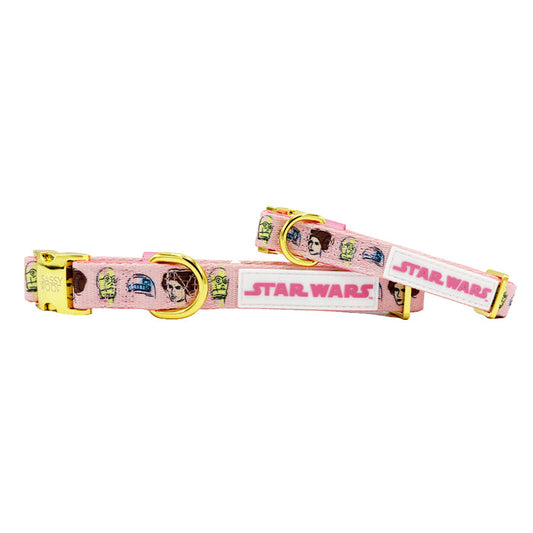 The Sassy Woof Dog Collar - STAR WARS™ Princess Leia is a pink collar with gold hardware, showcasing characters like Leia and a large Star Wars logo in a stylish design on a white background.