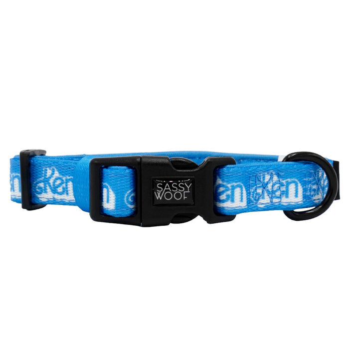 Introducing the Dog Collar Three Piece Bundle - KEN™ by Sassy Woof: a blue collar featuring white patterns and the signature SASSY WOOF branding on the black clasp. Designed with a sturdy black plastic buckle and a black metal D-ring, this stylish collar is perfectly coordinated to match your Ken leash or Ken waste bag holder for a seamless look.