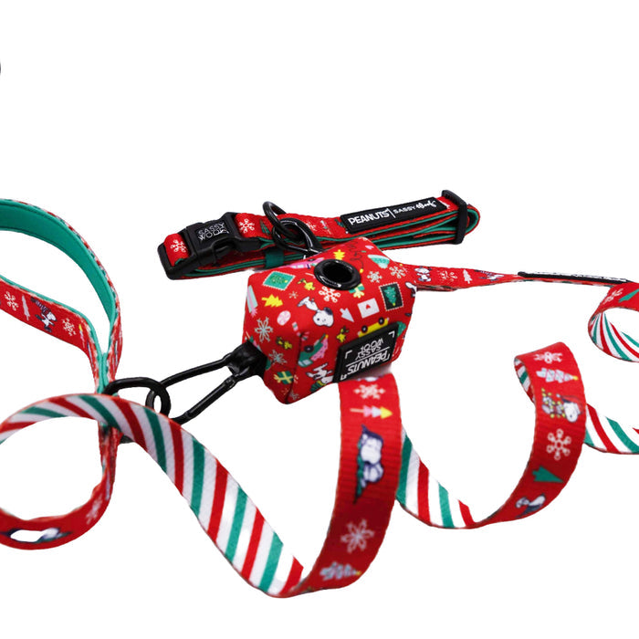 Celebrate the holidays with the Sassy Woof Dog Collar Three Piece Bundle - Peanuts™ Beagle Bells, featuring a red leash and harness set adorned with Christmas-themed patterns like snowflakes, trees, and charming Peanuts-inspired festive icons—all displayed on a white background for a cheerful accessory perfect for fans looking to treat their dogs to fun holiday style.