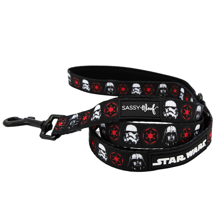 Introducing the Sassy Woof Dog Collar Three Piece Bundle - STAR WARS™ The Dark Side: a sleek black dog leash decorated with Stormtrooper helmets, striking red Imperial logos, and both SASSY WOOF and STAR WARS branding. It features a durable black metal clasp and is perfect for pairing with your favorite dog collar.