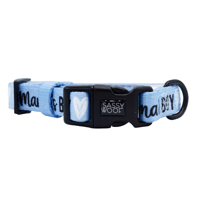 The Sassy Woof Dog Four Piece Bundle - Mama's Boy features a light blue adjustable collar with black buckle and D-ring, decorated with white hearts and text. Pairs perfectly with the Mama's Boy harness for a coordinated look.