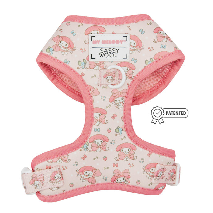The Sassy Woof Dog Four Piece Bundle - My Melody™ is a pink dog harness with cartoon characters and bows, part of the Hello Kitty pet accessories collection. It showcases the Sassy Woof logo and a Patented badge on the right side.