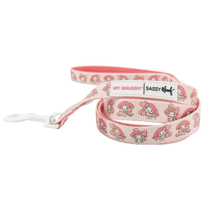 A pink dog leash featuring cartoon My Melody™ designs and Sassy Woof branding on a white label. Pairs perfectly with the Dog Four Piece Bundle - My Melody™ by Sassy Woof and other Hello Kitty pet accessories; features a white plastic clasp.