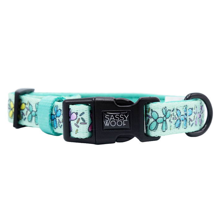 A light blue adjustable dog collar from Sassy Woof’s Dog Four Piece Bundle - Pup Pup Hooray features a black buckle, metal D-ring, and butterfly pattern—perfect for pairing with dog birthday accessories.