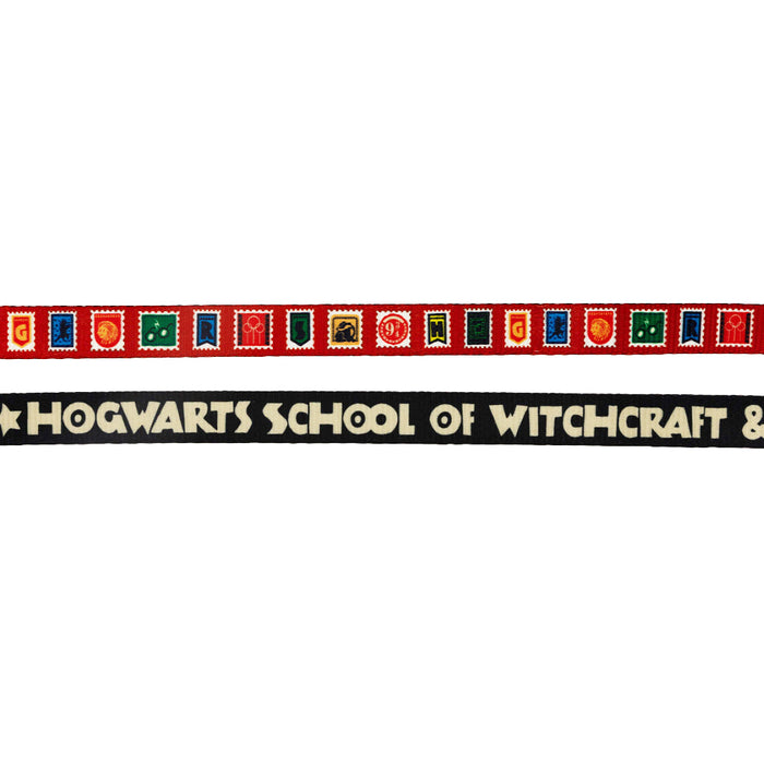 The Sassy Woof Dog Leash - Harry Potter™ Stamps features colorful "GRYFFINDOR" blocks above a sleek black ribbon with “HOGWARTS SCHOOL OF WITCHCRAFT &” in white—perfect for any magical Harry Potter fan and their pup.