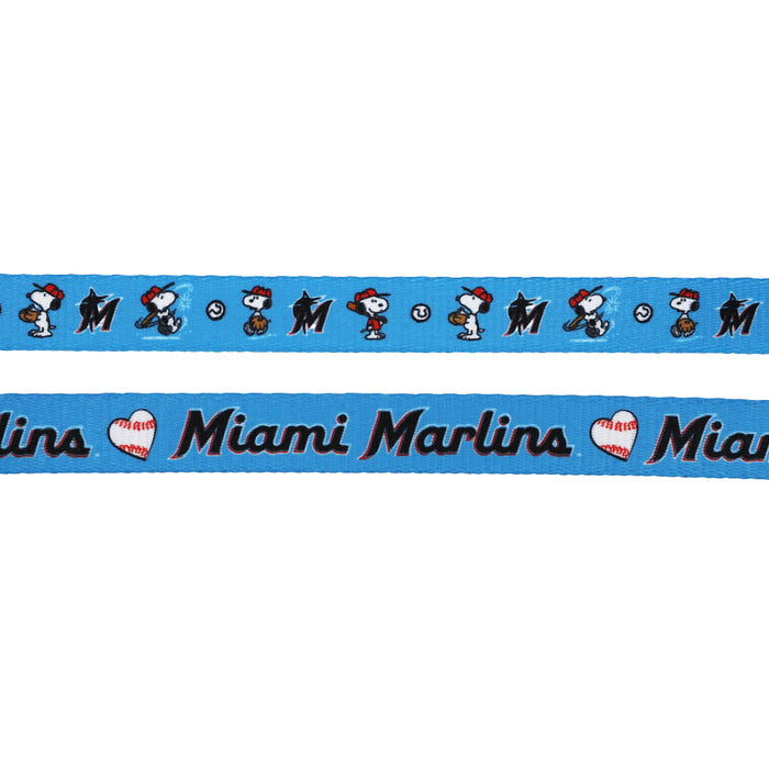 The Sassy Woof Dog Leash - MLB™ x Peanuts™ Miami Marlins™ features playful blue ribbon with Snoopy playing baseball, Miami Marlins logos, and "Miami Marlins" with a heart—perfect for fans and their pups.