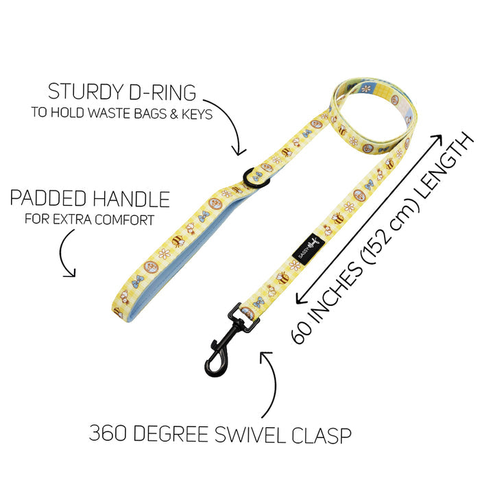 The Sassy Woof Dog Leash - Patch Perfect features a yellow neoprene padded handle, sturdy D-ring for bags or keys, 360° swivel clasp, and is 60 inches (152 cm) long, with black arrows and labels highlighting each feature.