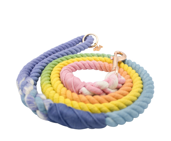 The Sassy Woof Dog Rope Leash - Sprinkles is a hand-crafted leash in pastel rainbow ombre—blue, purple, yellow, green, pink, orange—with a sturdy metal clasp and ring for securely attaching to your dog’s collar.