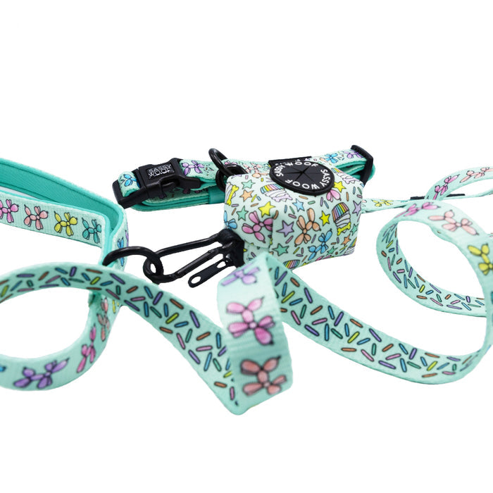 The Sassy Woof Dog Three Piece Bundle - Pup Pup Hooray, featuring a mint green collar, harness, and leash with colorful bow and sprinkle patterns, is stylishly tangled on a white background—ideal for dog birthdays.
