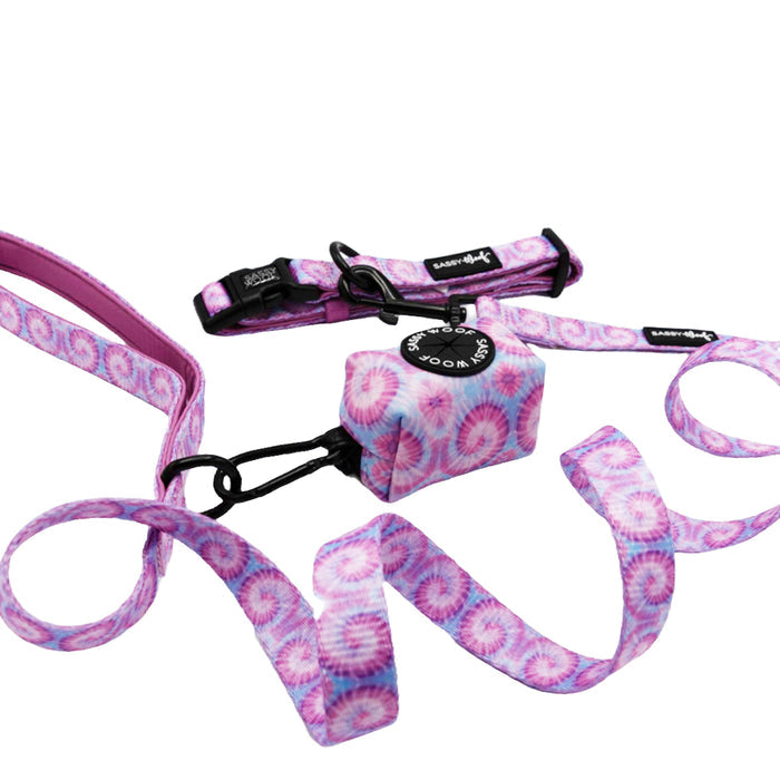 The Sassy Woof Dog Three Piece Bundle - Purple Haze includes a matching collar, leash, and waste bag holder with sleek black hardware, all showcased on a white background.