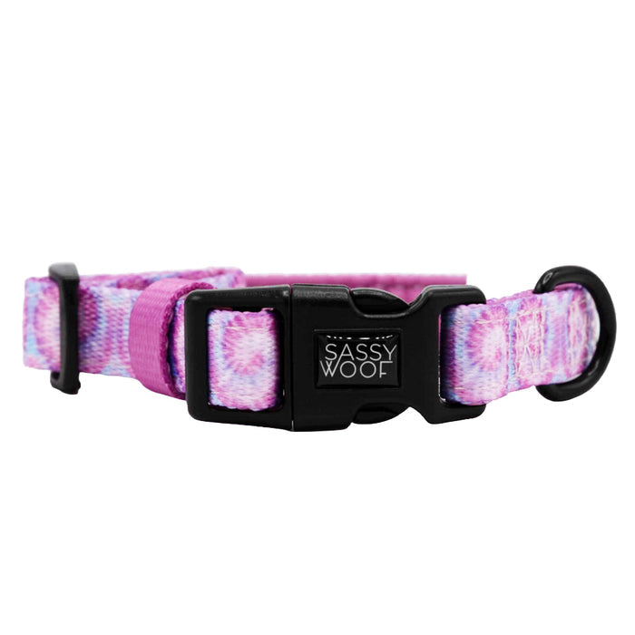 The Sassy Woof Dog Three Piece Bundle - Purple Haze includes a purple and pink tie-dye collar with black buckle, adjustable strap, matching leash, and waste bag holder—perfect for stylish walks!.