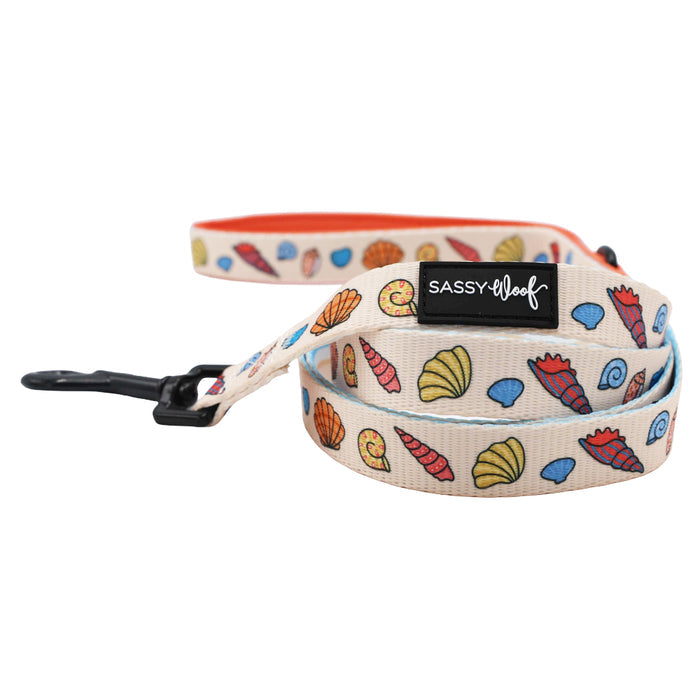 The Sassy Woof Dog Three Piece Bundle - Shell Yeah includes a beige beach dog leash with colorful seashell patterns and black metal clip, perfectly paired with our matching seashell dog collar.