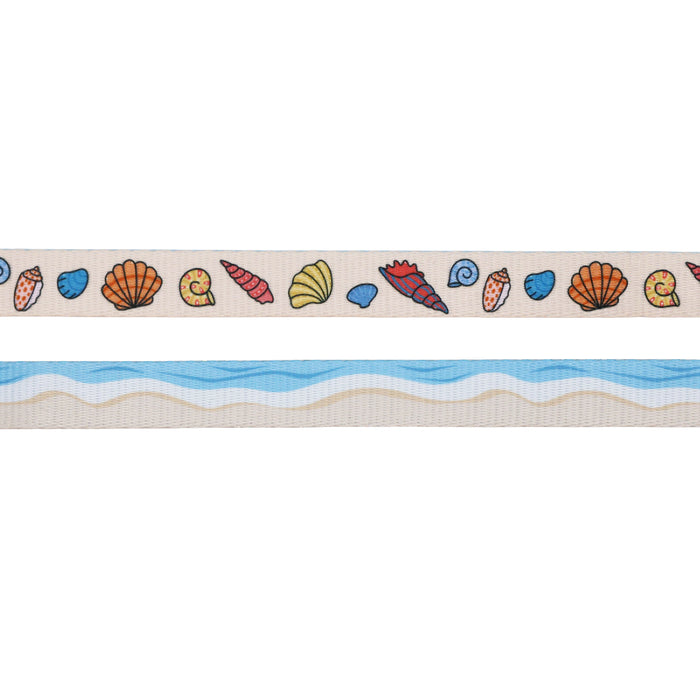 The Sassy Woof Dog Three Piece Bundle - Shell Yeah features two horizontal strips: the top has colorful seashells on beige, while the bottom displays blue waves and sandy tones, evoking the sea meeting the shore.