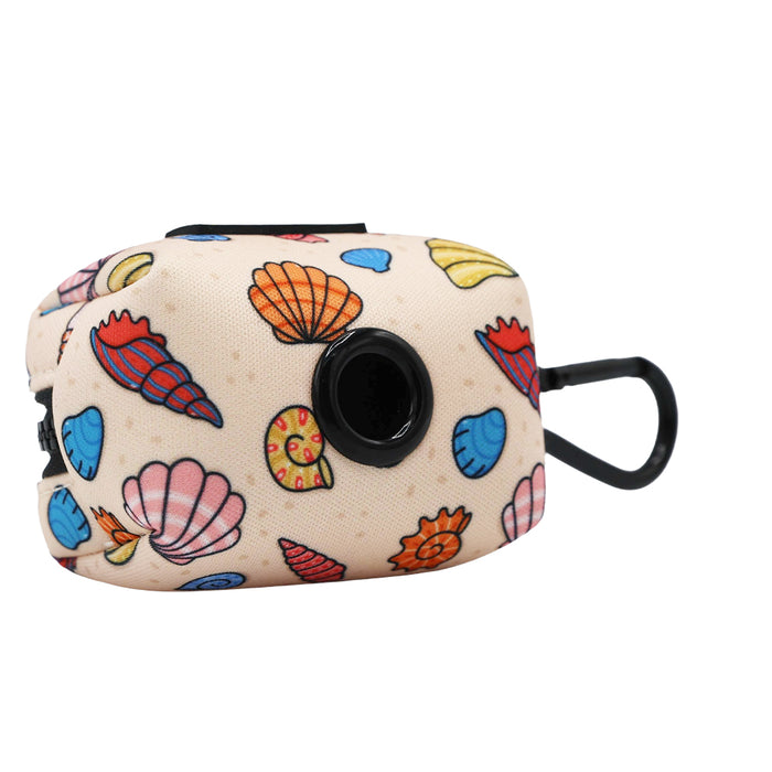 The Sassy Woof Dog Three Piece Bundle - Shell Yeah features a beige pouch with colorful seashells, a black circular opening, and clip—ideal for matching your seashell dog collar or beach leash on seaside walks.