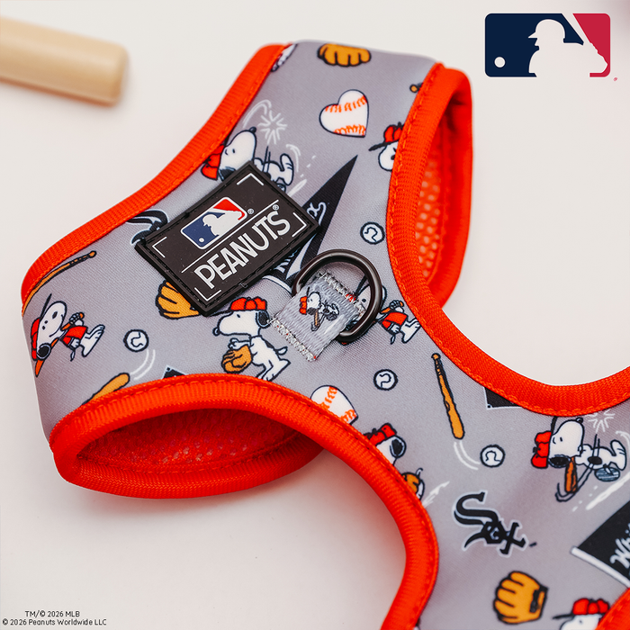 The Sassy Woof Dog Two Piece Bundle - MLB™ x Peanuts™ Chicago White Sox™ is a gray and orange harness with Peanuts characters playing baseball, team logos, a Peanuts patch, and the MLB logo on the top right.
