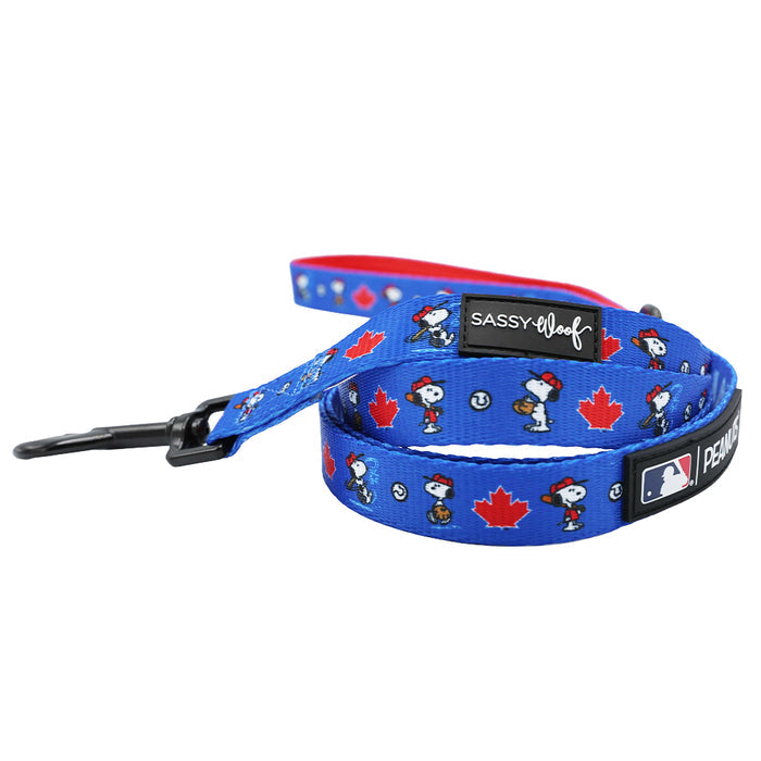 The Sassy Woof Dog Two Piece Bundle - MLB™ x Peanuts™ Toronto Blue Jays™ features a blue leash with red maple leaves, cartoon prints, a black clip, and MLB branding—perfect for matching your favorite dog harness!.