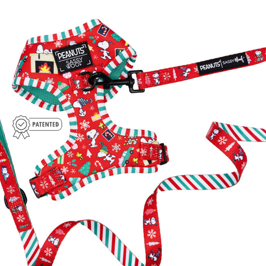 The Sassy Woof Dog Two Piece Bundle - Peanuts™ Beagle Bells features a festive harness and leash with Snoopy holiday designs, red, green, and white striped edges, plus a PATENTED badge displayed next to the harness.
