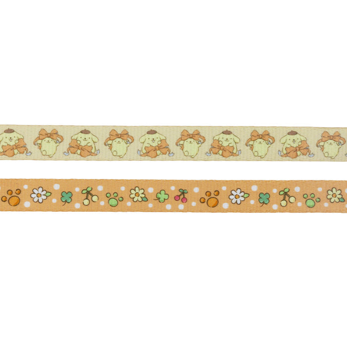 The Dog Two Piece Bundle - Pompompurin™ by Sassy Woof includes two decorative tapes: one with repeating cartoon dogs with orange bows, and another with flowers, paw prints, and dots on an orange background.
