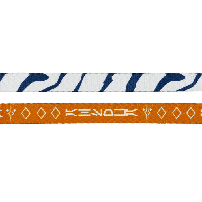 The Sassy Woof Dog Two Piece Bundle - STAR WARS™ Ahsoka features a white strap with dark blue wavy zebra-inspired stripes and an orange strap with white geometric shapes and stylized text for a unique dog harness look.