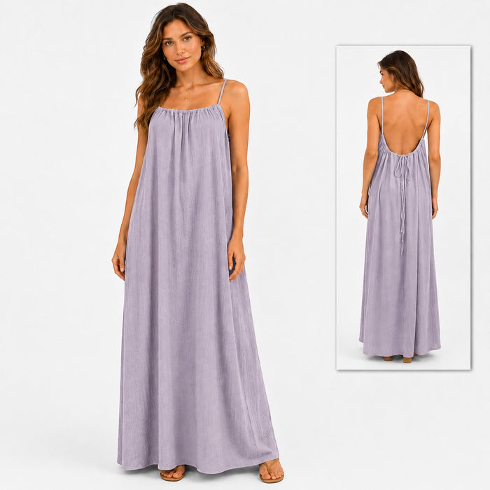 Model wearing a Tea-Shirt Shoppe lavender spaghetti strap maxi dress with a flowy, backless design and tie closure.