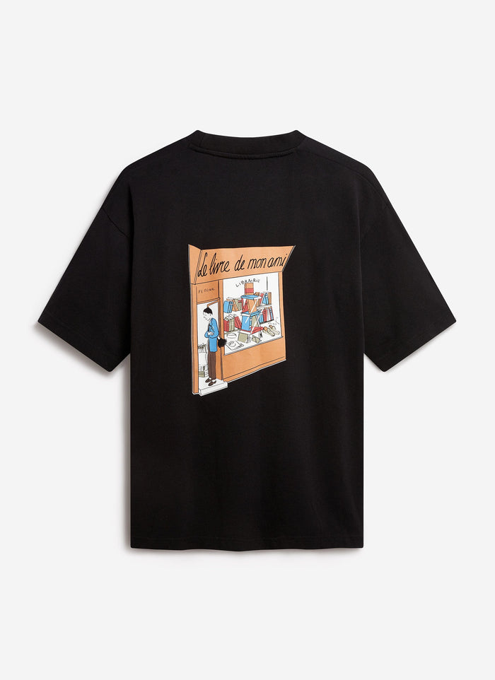 The back of the black Percival 'Le Livre De Mon Ami' oversized t-shirt with its colourful, illustrated bookshop graphic.