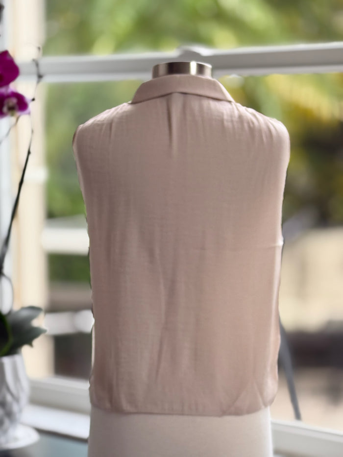 back of beige sleeveless satin blouse