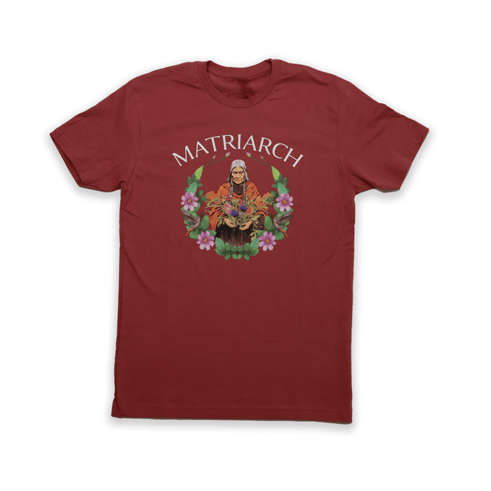 Matriarch Tee featuring an indigenous matriarch design on a red background, celebrating strength and wisdom.