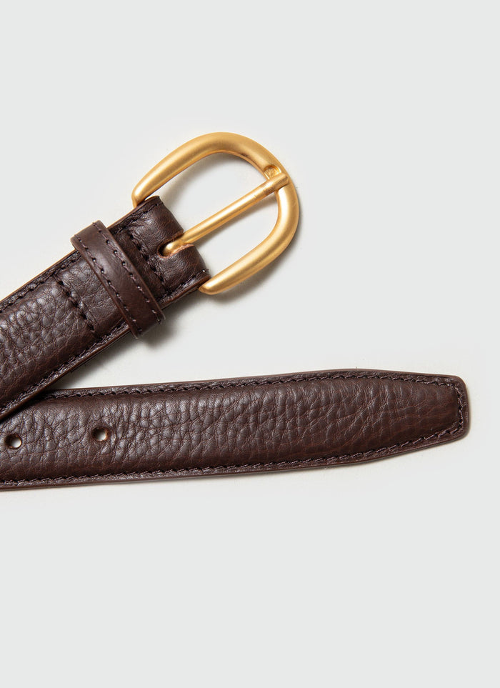 A close-up shot of the Percival brown leather dress belt, highlighting the classic gold buckle and textured leather.