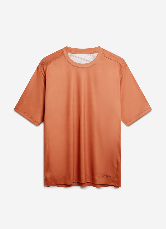 The Percival PCVL Performance Top in a rust colour, laid flat against a white studio background.