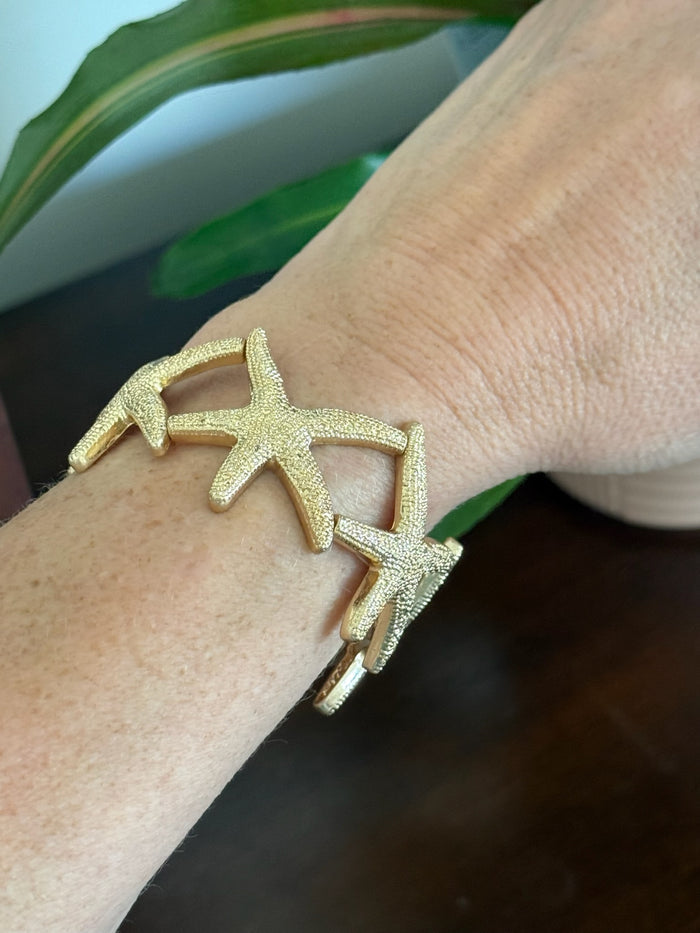 Large gold starfish stretch bracelet on model