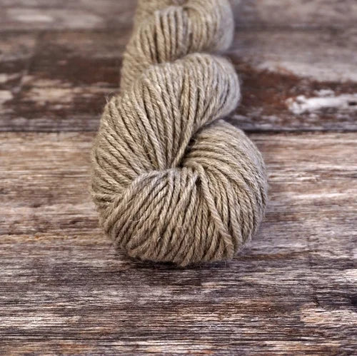 Ball of yarn on a wooden surface 9806_Bare_Necessities Nua Sport
