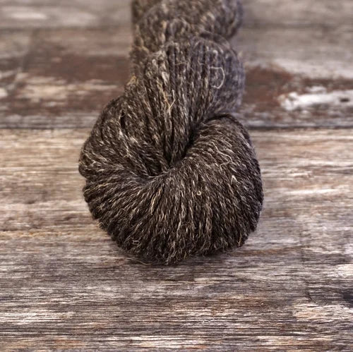 Brown skein of yarn on a wooden surface 9805_Capall Nua Sport