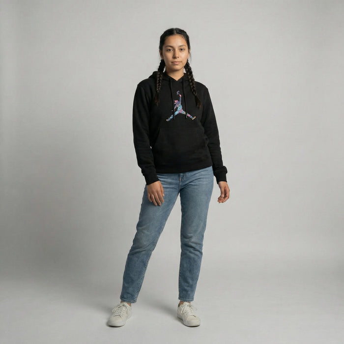 Model wearing Tribal Leap Hoodie in black with colorful graphic, paired with light blue jeans.