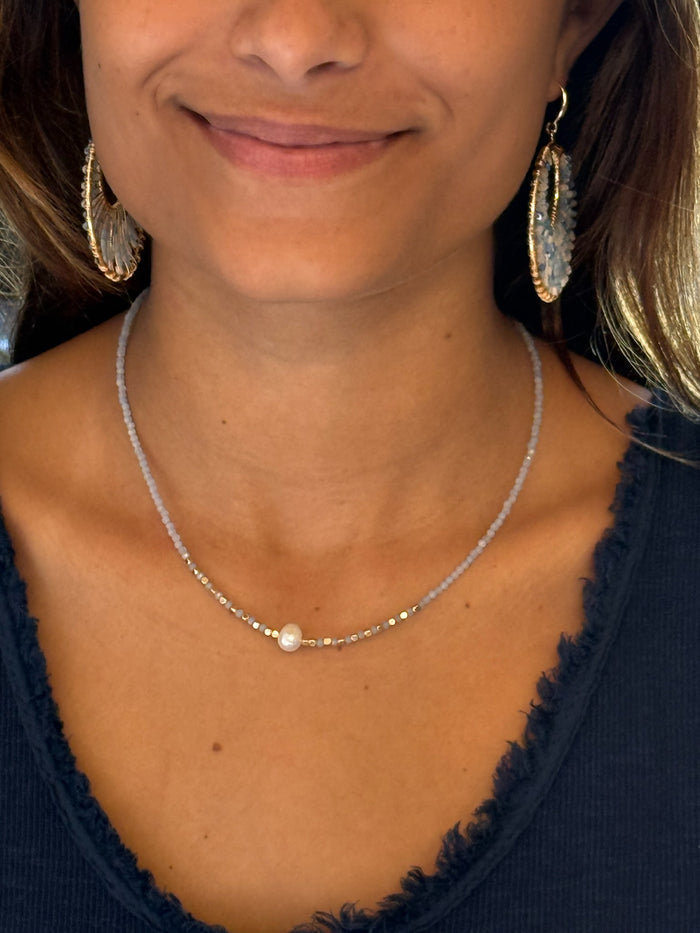 blue beaded necklace with a single pearl